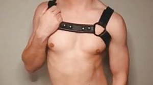 hot young man with harness jerking stay away from