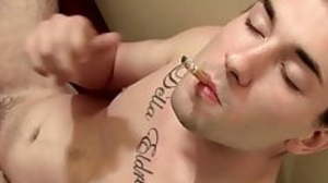 Tattooed twink chain-smoking while jerking off big